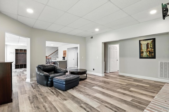 1069 Pleasant Valley Rd, Greenbrier, TN 37073 - living area featuring a drop ceiling, light wood finished floors, stairway, and recessed lighting