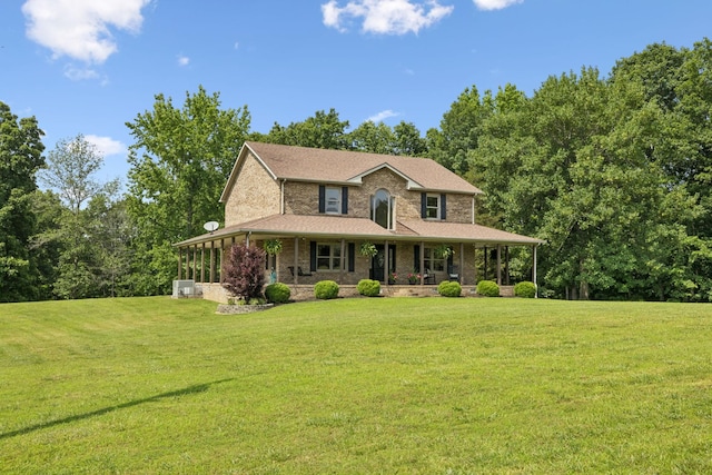 4255 Mcfall Rd, Cumberland City, TN 37050 - country-style home with covered porch, a front yard, and brick siding