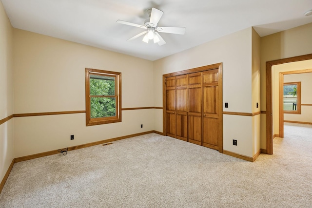 4255 Mcfall Rd, Cumberland City, TN 37050 - unfurnished bedroom with multiple windows, carpet floors, and a closet