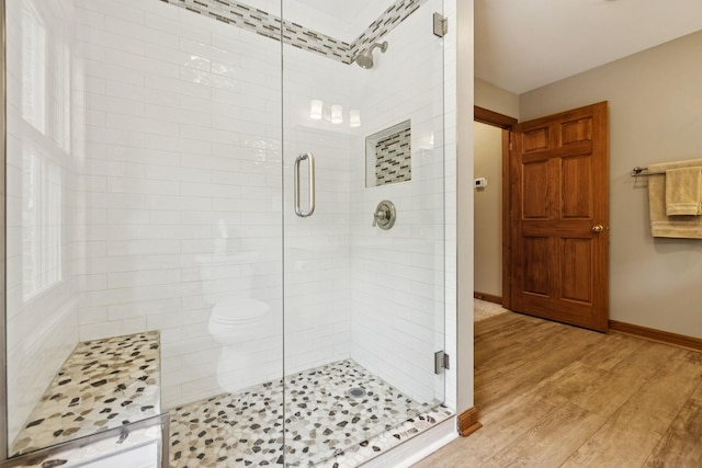 4255 Mcfall Rd, Cumberland City, TN 37050 - bathroom featuring a stall shower and wood finished floors