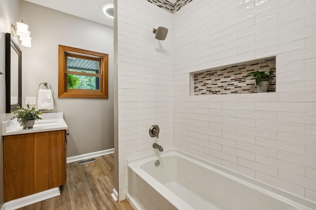 4255 Mcfall Rd, Cumberland City, TN 37050 - bathroom featuring wood finished floors, vanity, and washtub / shower combination