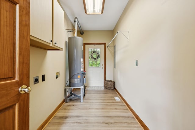 4255 Mcfall Rd, Cumberland City, TN 37050 - washroom featuring gas water heater, cabinet space, hookup for an electric dryer, light wood-style flooring, and electric panel