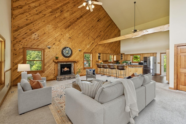 4255 Mcfall Rd, Cumberland City, TN 37050 - living area with high vaulted ceiling, ceiling fan, plenty of natural light, a brick fireplace, and wooden walls