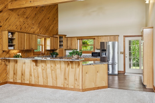 4255 Mcfall Rd, Cumberland City, TN 37050 - kitchen with stainless steel appliances, high vaulted ceiling, a peninsula, a breakfast bar area, and dark carpet