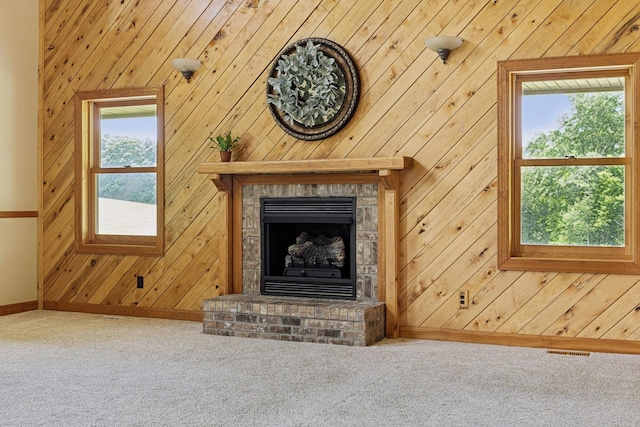 4255 Mcfall Rd, Cumberland City, TN 37050 - detailed view of carpet floors, wooden walls, and a fireplace with raised hearth