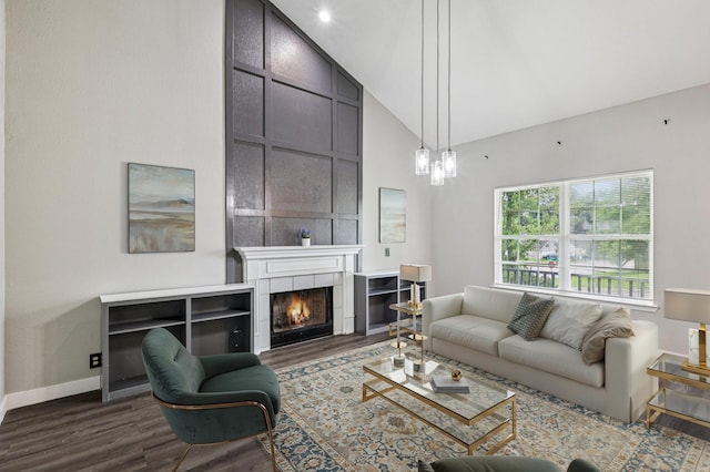 180 Bill Stewart Blvd, La Vergne, TN 37086 - living room featuring dark wood-type flooring, high vaulted ceiling, and a tiled fireplace