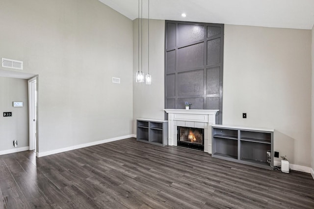 180 Bill Stewart Blvd, La Vergne, TN 37086 - unfurnished living room with dark wood-type flooring, a fireplace, and a towering ceiling