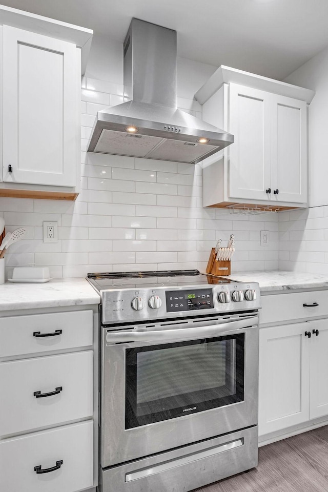 5171 Whites Creek Pike, Whites Creek, TN 37189 - kitchen with electric stove, wall chimney exhaust hood, tasteful backsplash, and white cabinets