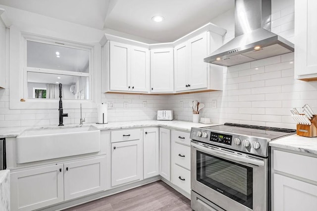 5171 Whites Creek Pike, Whites Creek, TN 37189 - kitchen with stainless steel electric range, wall chimney range hood, backsplash, white cabinetry, and recessed lighting