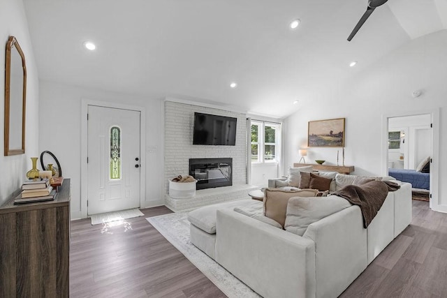 5171 Whites Creek Pike, Whites Creek, TN 37189 - living area featuring vaulted ceiling, a brick fireplace, wood finished floors, a ceiling fan, and recessed lighting
