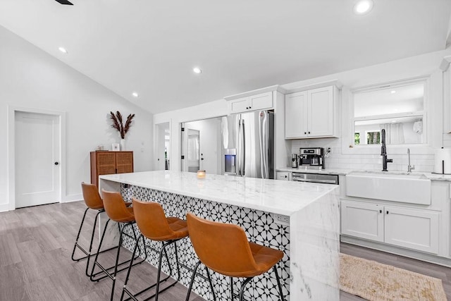 5171 Whites Creek Pike, Whites Creek, TN 37189 - kitchen with stainless steel appliances, a kitchen island, recessed lighting, white cabinets, and backsplash