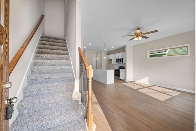 1906 Evans Rd, Clarksville, TN 37042 - stairway featuring ceiling fan, wood finished floors, and recessed lighting