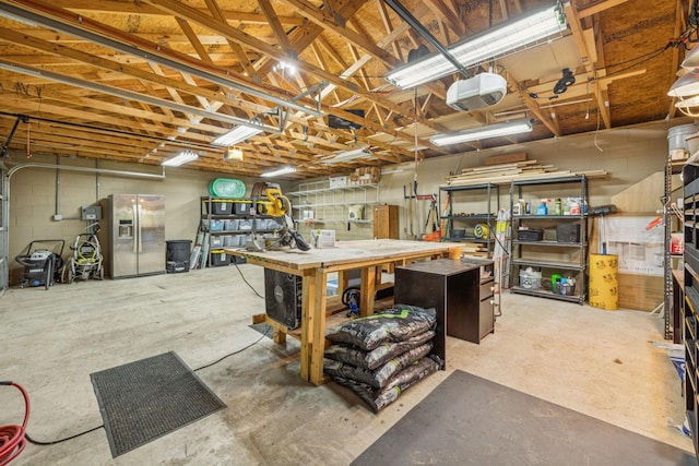 204 Eldon Ct, Nashville, TN 37214 - below grade area featuring stainless steel fridge, a workshop area, and a garage