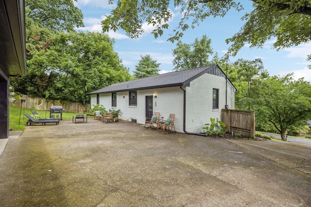 204 Eldon Ct, Nashville, TN 37214 - back of property with brick siding, a patio area, and a fire pit