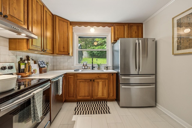 204 Eldon Ct, Nashville, TN 37214 - kitchen with appliances with stainless steel finishes, under cabinet range hood, brown cabinets, light countertops, and backsplash