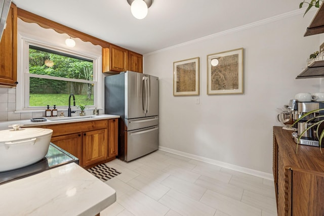 204 Eldon Ct, Nashville, TN 37214 - kitchen featuring freestanding refrigerator, brown cabinetry, light countertops, and crown molding