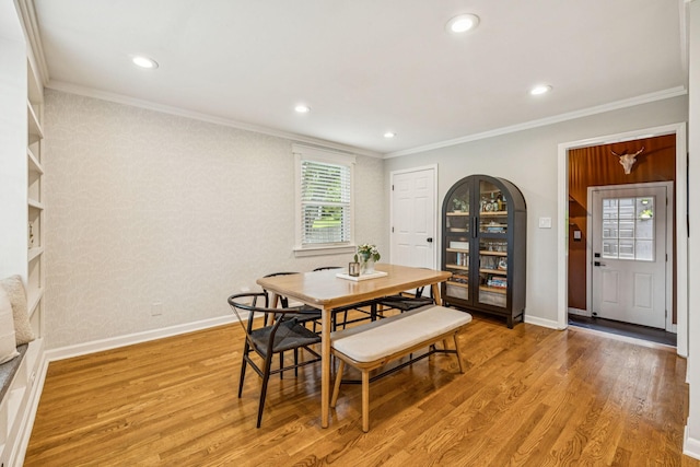 204 Eldon Ct, Nashville, TN 37214 - dining room featuring crown molding, light wood finished floors, arched walkways, and recessed lighting