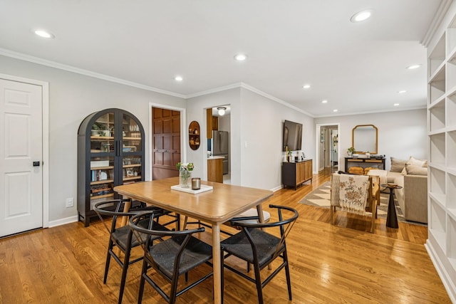 204 Eldon Ct, Nashville, TN 37214 - dining room featuring recessed lighting, light wood finished floors, ornamental molding, and arched walkways