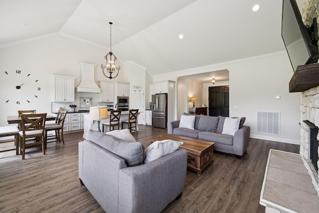 623 Josef Cir, Columbia, TN 38401 - living room with high vaulted ceiling, a stone fireplace, a chandelier, dark wood finished floors, and ornamental molding