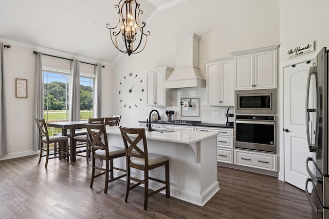623 Josef Cir, Columbia, TN 38401 - kitchen with appliances with stainless steel finishes, custom range hood, crown molding, decorative backsplash, and a chandelier