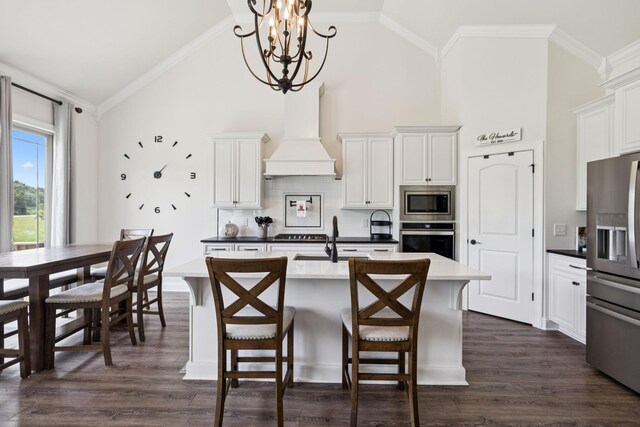 623 Josef Cir, Columbia, TN 38401 - kitchen with stainless steel appliances, premium range hood, high vaulted ceiling, a kitchen island with sink, and a chandelier