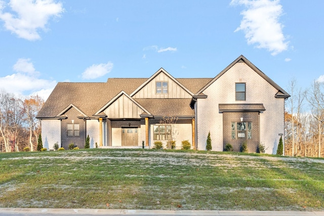 1311 Reda Dr, Clarksville, TN 37042 - view of front facade with brick siding, board and batten siding, and a front lawn