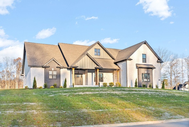 1311 Reda Dr, Clarksville, TN 37042 - view of front of house featuring brick siding, a front lawn, and board and batten siding