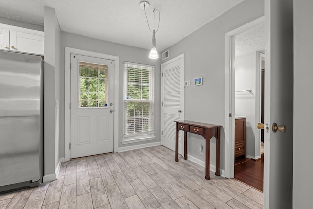 1029 Rachels Square Dr, Hermitage, TN 37076 - entryway featuring a textured ceiling and light wood-style flooring