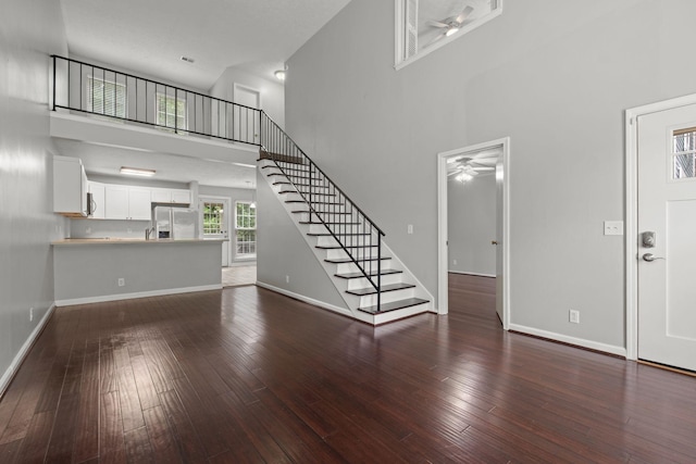 1029 Rachels Square Dr, Hermitage, TN 37076 - unfurnished living room with a ceiling fan, a towering ceiling, wood-type flooring, and stairs