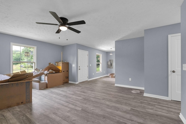 128 N C St, Hillsboro, TN 37342 - living room with healthy amount of natural light, ceiling fan, wood finished floors, and a textured ceiling
