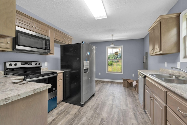 128 N C St, Hillsboro, TN 37342 - kitchen featuring stainless steel appliances, light countertops, light wood-style floors, a textured ceiling, and hanging light fixtures
