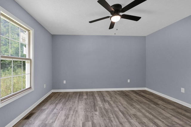128 N C St, Hillsboro, TN 37342 - unfurnished room with dark wood finished floors, a ceiling fan, and a textured ceiling
