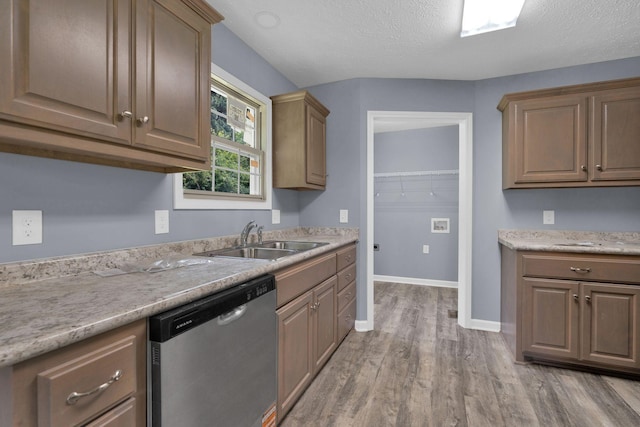 128 N C St, Hillsboro, TN 37342 - kitchen featuring dishwasher, light wood-style flooring, light countertops, and a textured ceiling