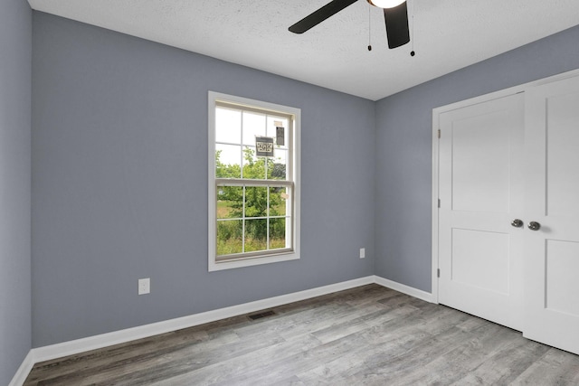 128 N C St, Hillsboro, TN 37342 - unfurnished bedroom with wood finished floors and a ceiling fan