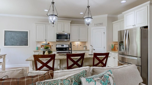 15505 Versailles Rd, Rockvale, TN 37153 - kitchen featuring stainless steel appliances, backsplash, light stone countertops, decorative light fixtures, and an island with sink