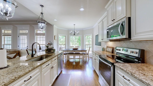 15505 Versailles Rd, Rockvale, TN 37153 - kitchen with stainless steel appliances, a chandelier, wood finished floors, decorative backsplash, and white cabinets