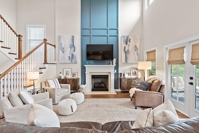 2213 Kirkwall Dr, Nolensville, TN 37135 - living room featuring a towering ceiling, wood finished floors, stairs, and a fireplace with flush hearth