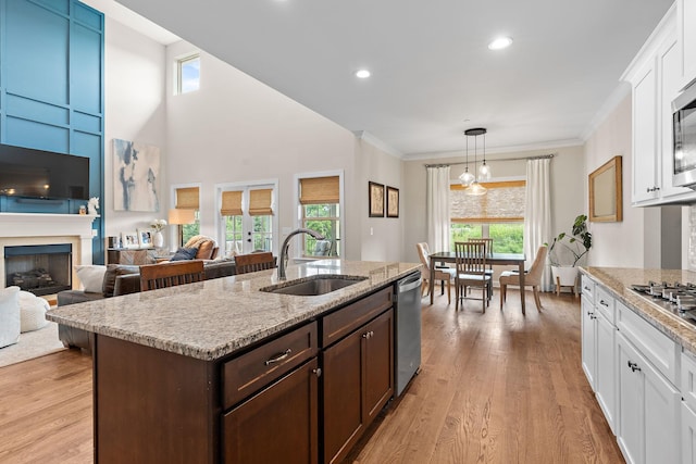 2213 Kirkwall Dr, Nolensville, TN 37135 - kitchen featuring appliances with stainless steel finishes, dark brown cabinetry, healthy amount of natural light, white cabinetry, and ornamental molding