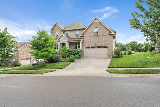 2213 Kirkwall Dr, Nolensville, TN 37135 - view of front facade featuring a front lawn, concrete driveway, a garage, and brick siding