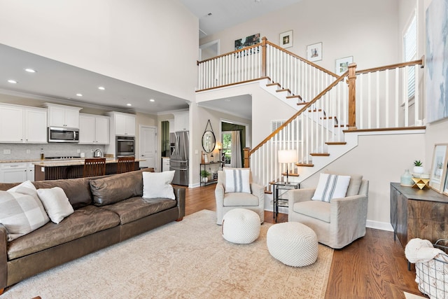 2213 Kirkwall Dr, Nolensville, TN 37135 - living room with dark wood-type flooring, a high ceiling, recessed lighting, stairway, and crown molding