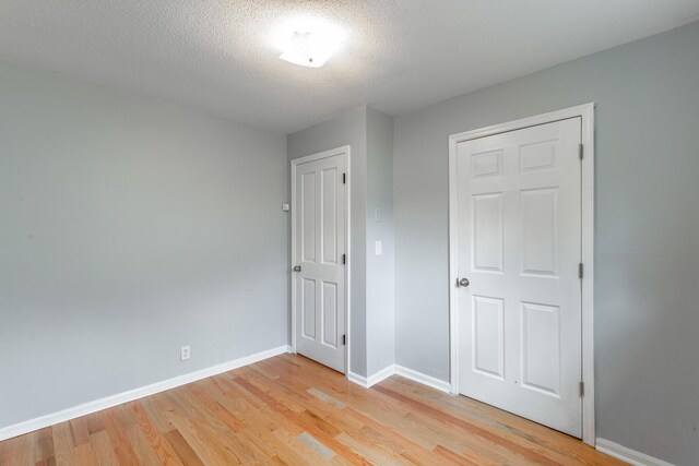 3405 Elder Mountain Rd, Chattanooga, TN 37419 - unfurnished bedroom with light wood finished floors and a textured ceiling