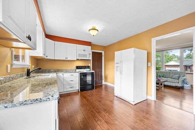 19 Garth Dr, Clarksville, TN 37040 - kitchen with white appliances, white cabinetry, light stone counters, dark wood-type flooring, and a textured ceiling