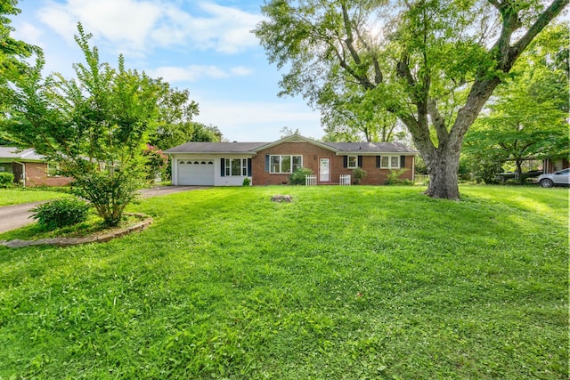 19 Garth Dr, Clarksville, TN 37040 - ranch-style house featuring asphalt driveway, an attached garage, a front lawn, and brick siding