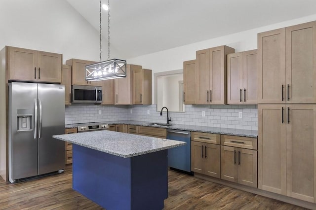 130 Rachelle Pl, Baxter, TN 38544 - kitchen featuring appliances with stainless steel finishes, tasteful backsplash, a center island, light stone counters, and dark wood-style floors