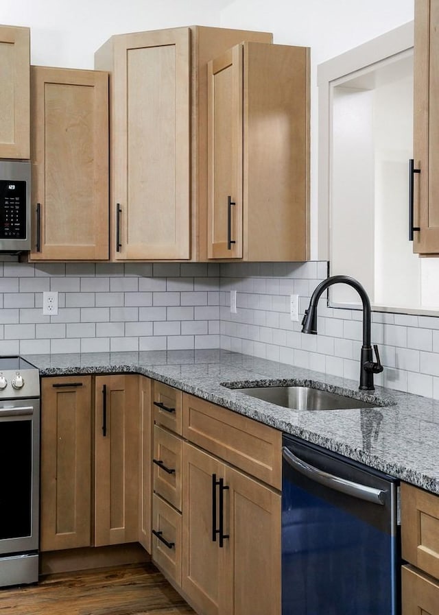 130 Rachelle Pl, Baxter, TN 38544 - kitchen with stainless steel appliances, light stone counters, dark wood-style flooring, and backsplash