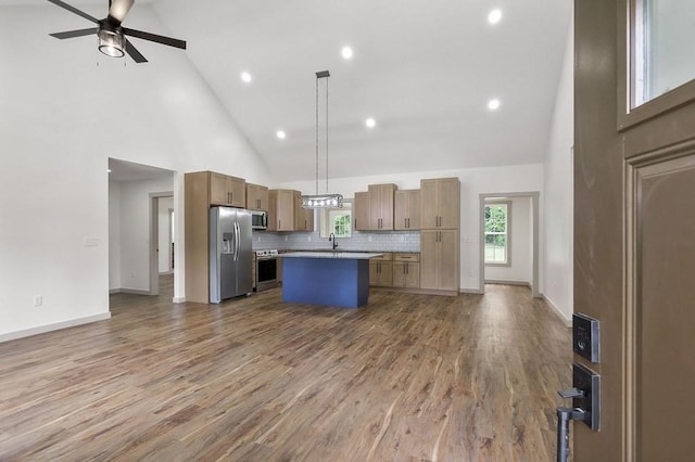 130 Rachelle Pl, Baxter, TN 38544 - kitchen with stainless steel appliances, high vaulted ceiling, open floor plan, a center island, and backsplash