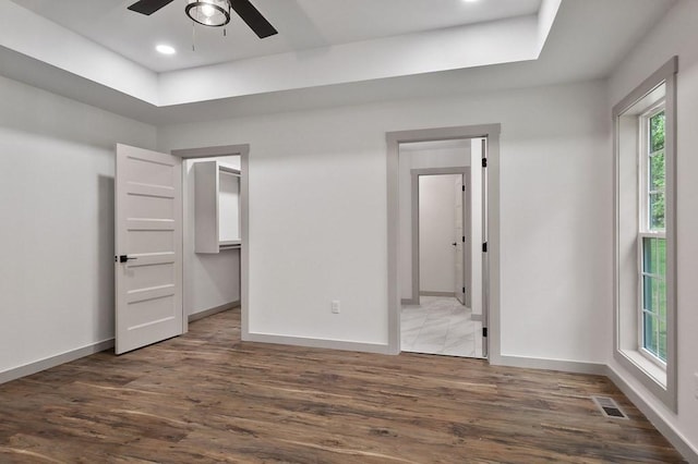 130 Rachelle Pl, Baxter, TN 38544 - unfurnished bedroom featuring wood finished floors, a tray ceiling, recessed lighting, a spacious closet, and ensuite bathroom