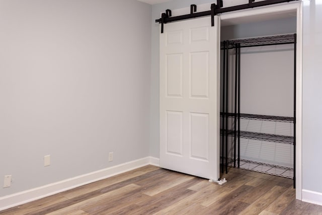 1280 Middle Tennessee Blvd Unit E14, Murfreesboro, TN 37130 - unfurnished bedroom with wood finished floors and a barn door