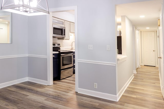 1280 Middle Tennessee Blvd Unit E14, Murfreesboro, TN 37130 - kitchen with stainless steel appliances, light wood-type flooring, a chandelier, recessed lighting, and light countertops