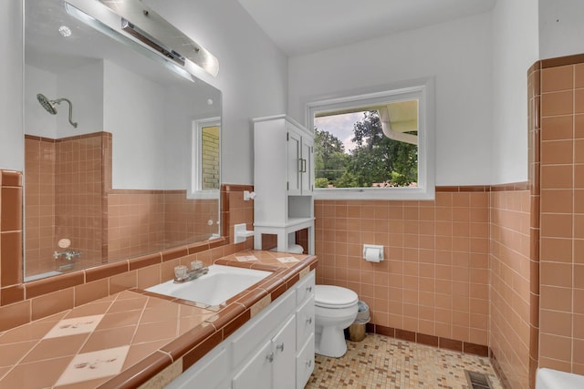 1118 Houston Dr, Murfreesboro, TN 37130 - bathroom featuring tile walls, vanity, a shower, wainscoting, and tile patterned flooring